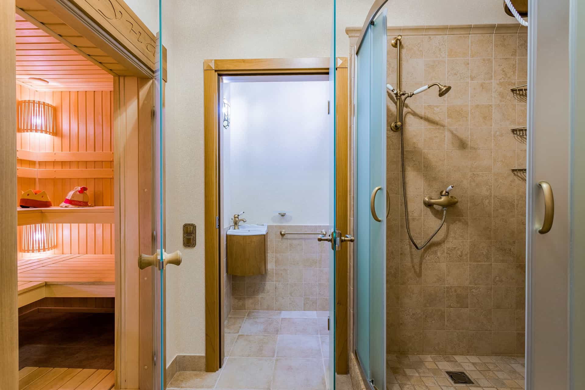 A tiled shower enclosure with steam and water on the glass