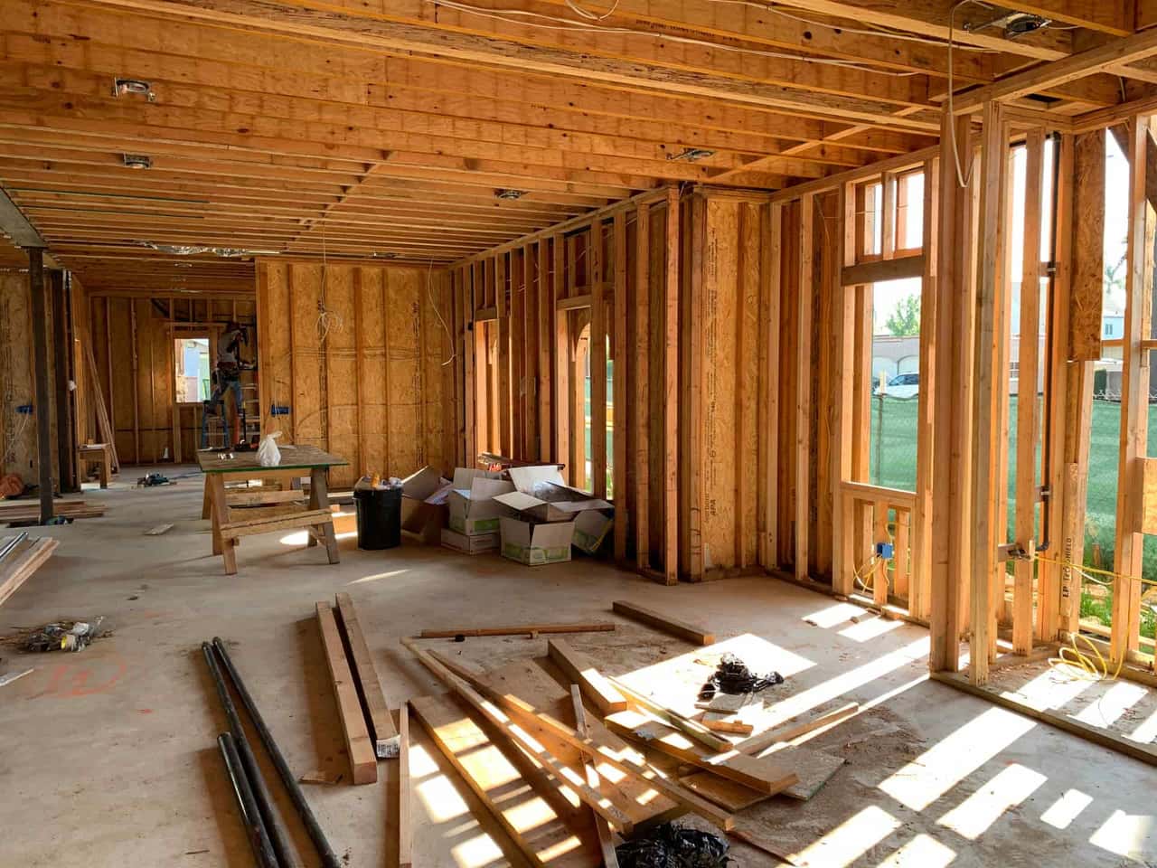 A low crawl space beneath a house, joists and piers visible
