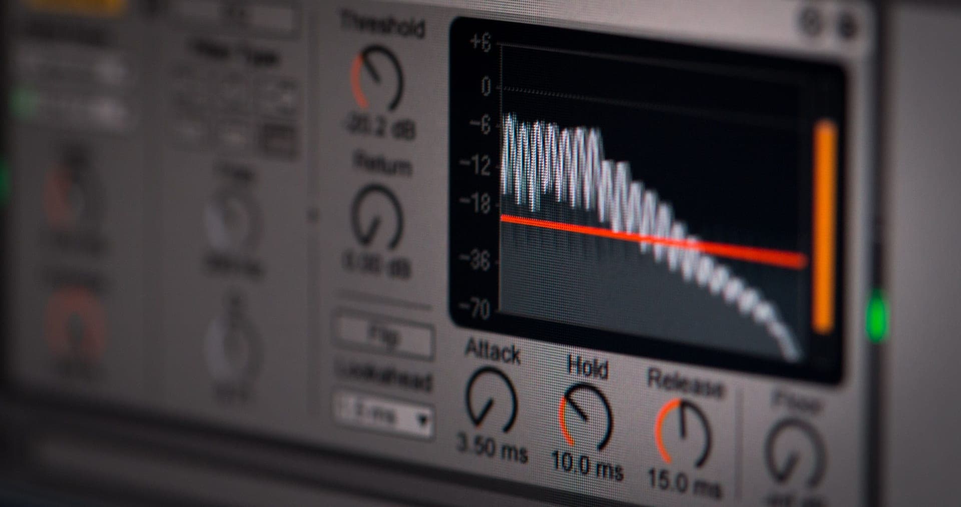 An audio level meter glowing in a dark room