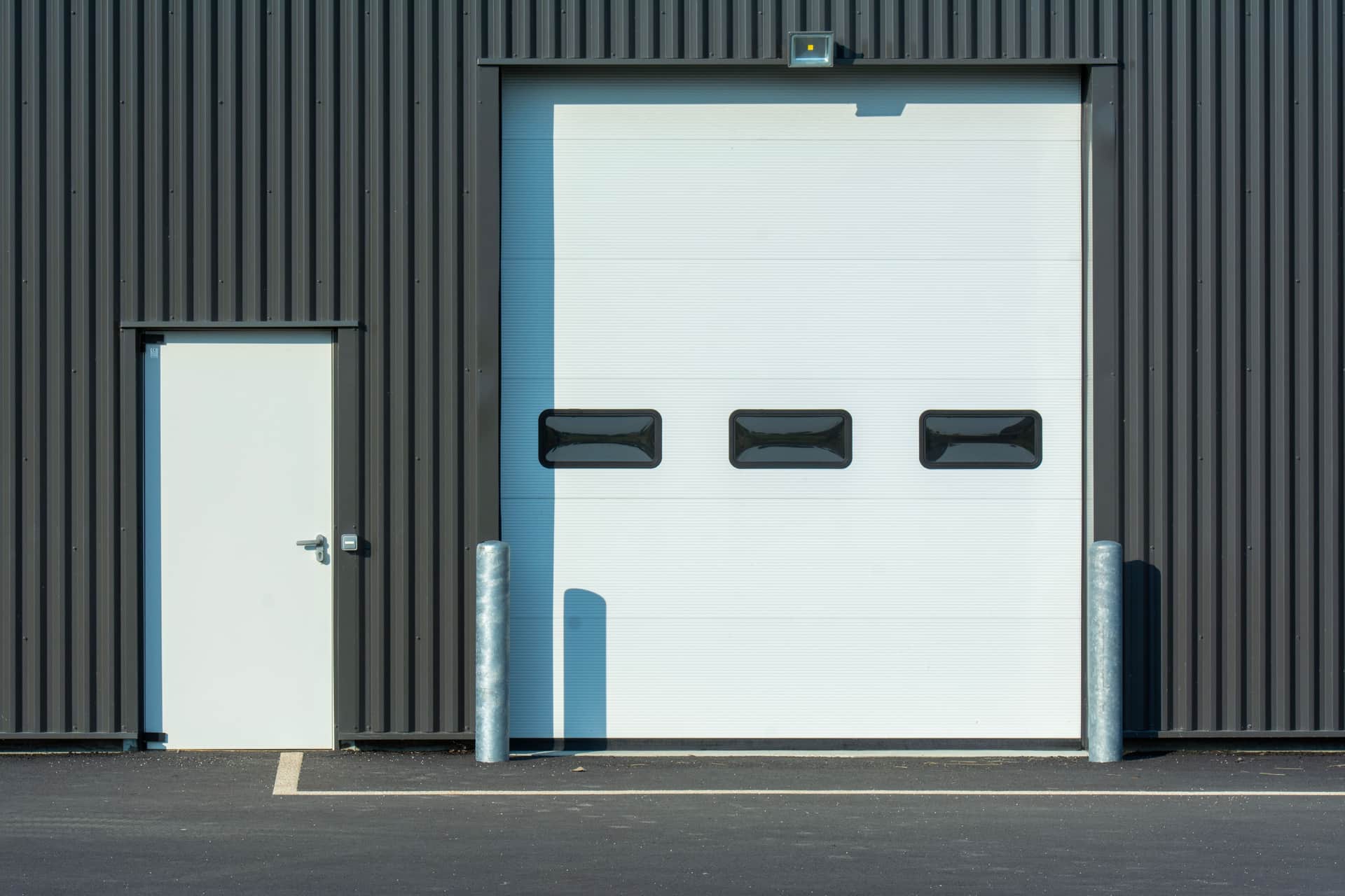 Two identical industrial doors side by side in a plain wall