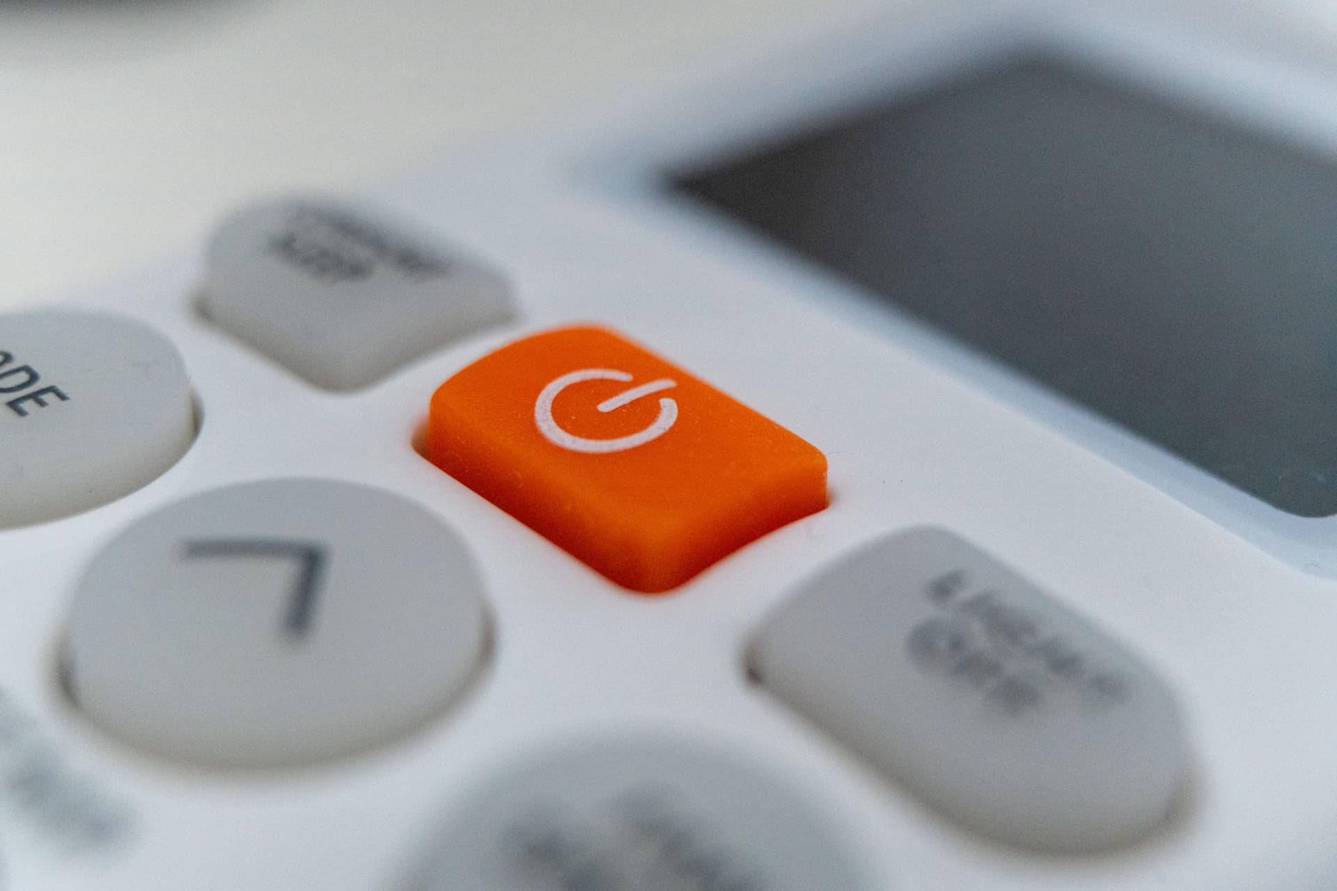 The control panel of a white household appliance, buttons in close-up